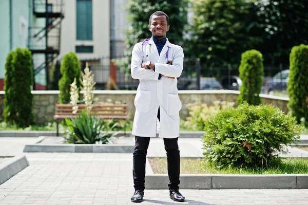 African american doctor male at lab coat with stethoscope outdoor.