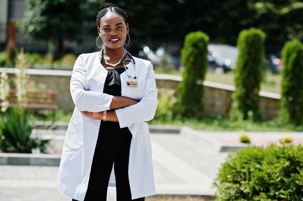 African american doctor female at lab coat with stethoscope outdoor.