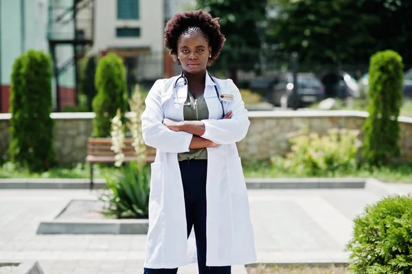 African american doctor female at lab coat with stethoscope outdoor.