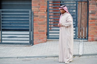 Middle Eastern arab man posed on street against modern building. clipart