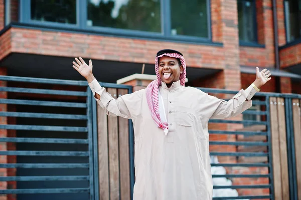 Orta Doğu Arap adam sokakta modern bina karşı yöneltilen dilini gösterir.