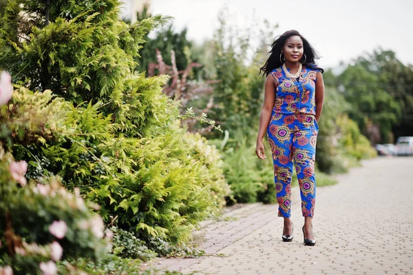 African american girl in coloured clothes posed outdoor. Fashionable black woman.