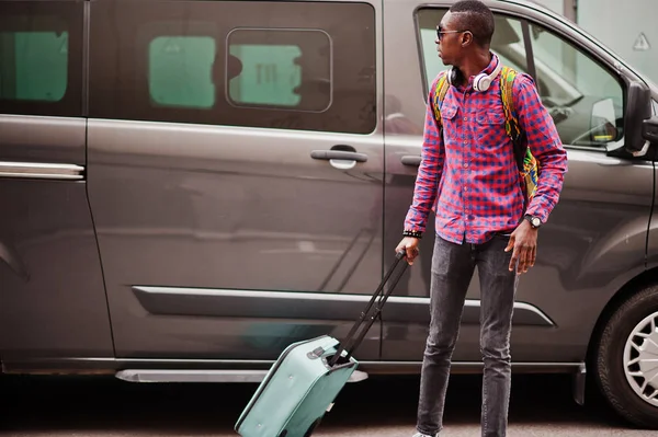 格子縞のシャツ サングラス スーツケースとバックパックのイヤホンでアフリカ系アメリカ人 バンの車に対して 黒人男性旅行者 — ストック写真