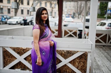 Geleneksel violet saree Hint hindu kıza karşı ahşap teras Street poz verdi.
