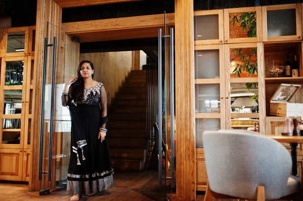 Restoranda poz siyah sari giysili güzel Hintli kız. 