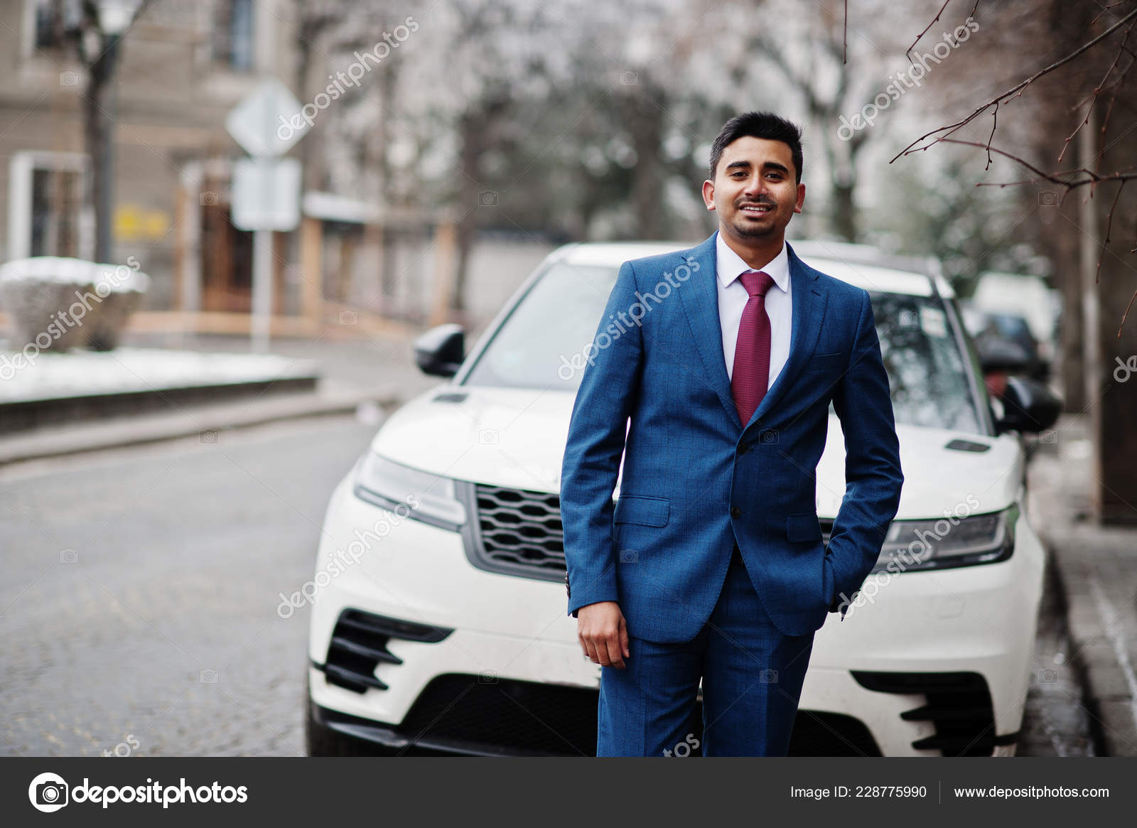 Handsome Stylish Man Leaning On Car And Posing Near Garage Stock Photo,  Picture and Royalty Free Image. Image 128145240.