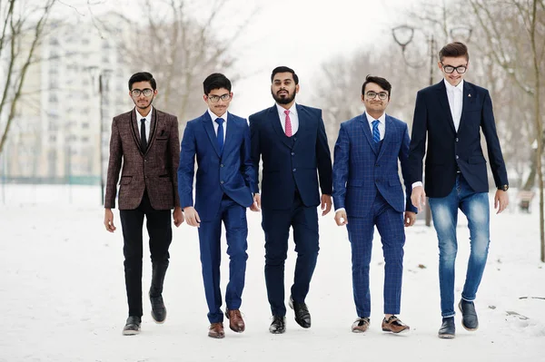 Group of five indian businessman in suits posed and walking outdoor in winter day at Europe.