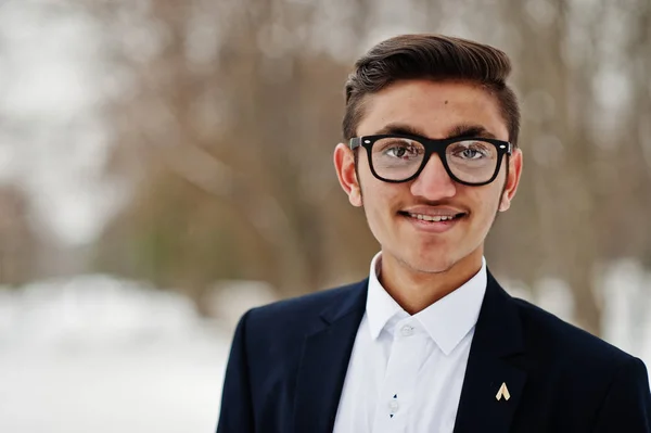 Close up portrait of stylish indian student man in suit and glasses posed at winter day outdoor.