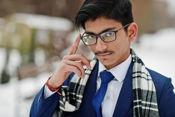 Close up portrait of stylish indian student man in suit, glasses and scarf posed at winter day outdoor.