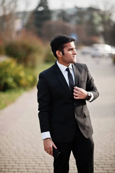 Elegant south asian indian business man in black suit.