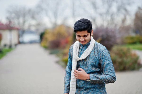 Indian man wear on traditional clothes with white scarf posed outdoor.