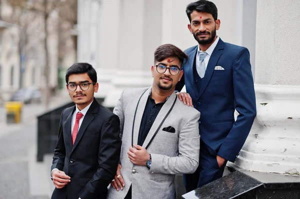 Group of three south asian indian mans in business suits wear.
