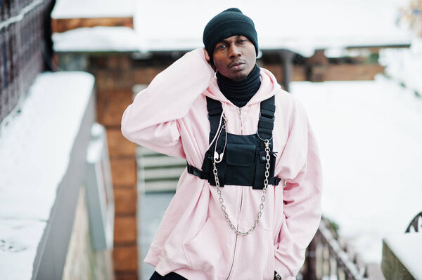 Stylish urban style african american man in pink hoodie posed at winter day.