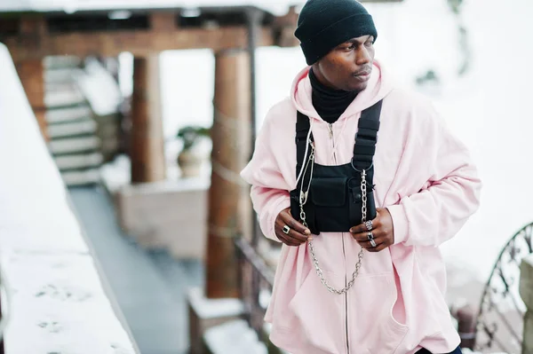 Stylish urban style african american man in pink hoodie posed at winter day.