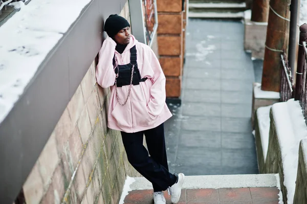 Stylish urban style african american man in pink hoodie posed at winter day.