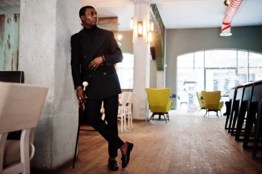 Zarif siyah ceket, holding retro baston baston şişesi veya altın elmas topu saplı tippling kamışı olarak şık Afro-Amerikan beyefendi. Zengin moda afro adam.