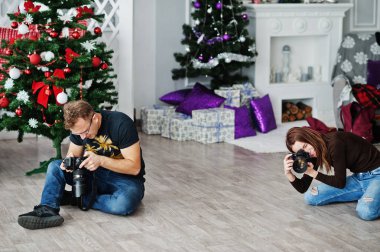 The team of two photographers shooting on studio. Professional photographer on work. clipart
