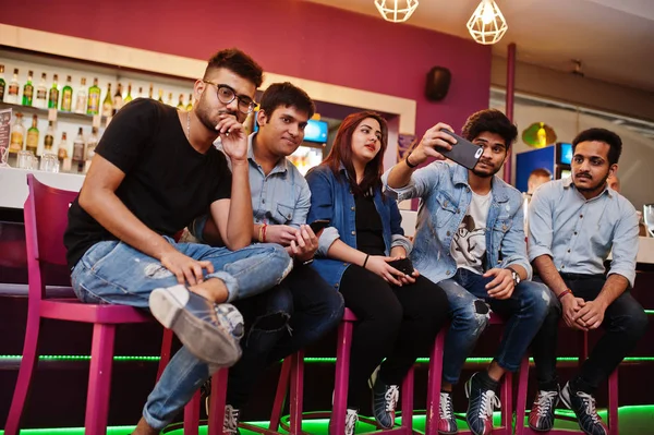 Group of stylish asian friends wear on jeans sitting at chairs a — Stock Photo, Image