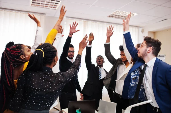 Multiracial business people standing at office and put hands up.