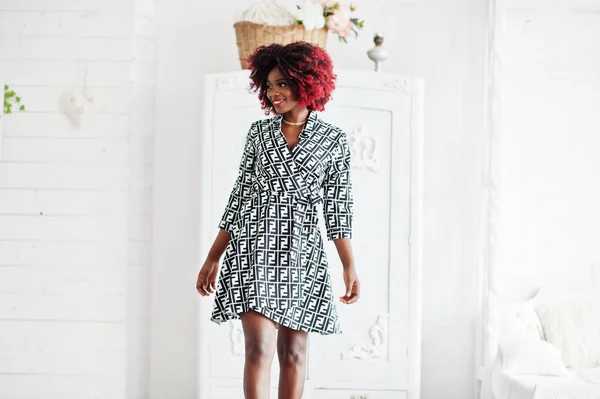 Fashionable tall african american model woman with red afro hair