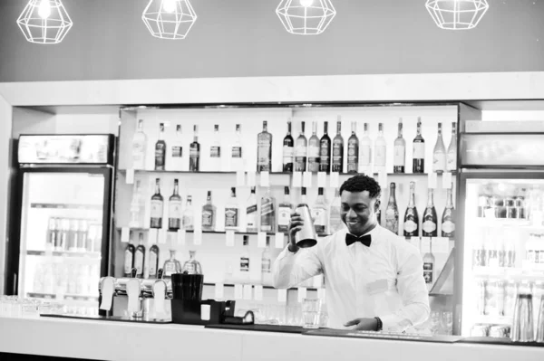 African american bartender at bar with shaker. Alcoholic beverag