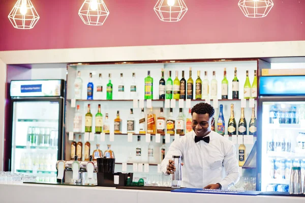 African american bartender at bar with shaker. Alcoholic beverag