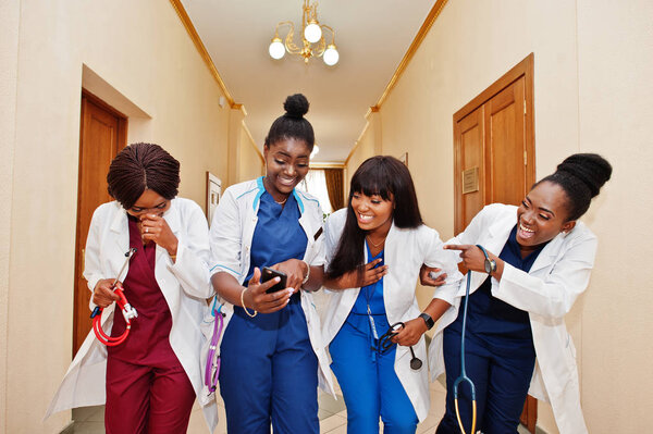 Group of female african medical students in college looking on p