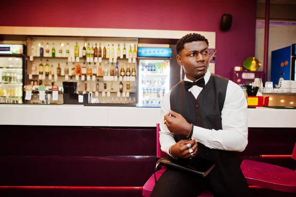 Young handsome african man wearing white shirt, black vest and b — Stockfoto