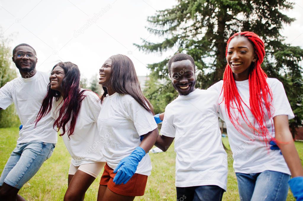 Group happy african volunteers hugs together in park. Africa vol