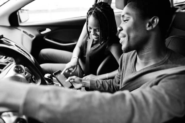 Beautiful young african american couple sitting on the front pas