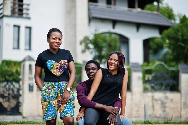 Three african american friends posed outdoor together.