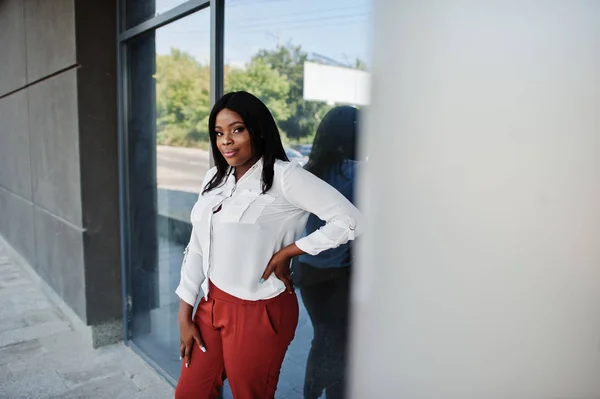 Formally dressed african american business woman in white blouse