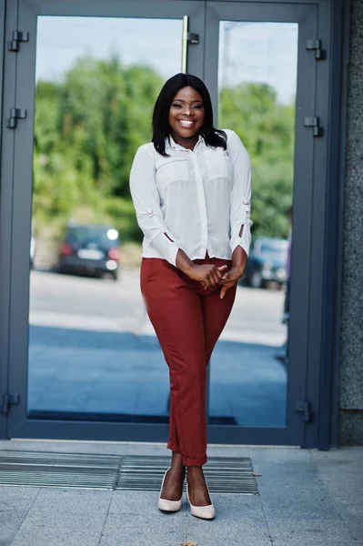 Formally dressed african american business woman in white blouse