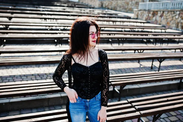 Retrato de chica morena en gafas de color rosa llevar en negro posado ou — Foto de Stock