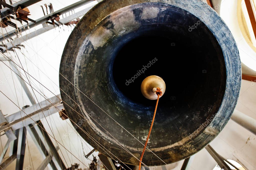 Close-up view of metal orthodox church bells in tower.