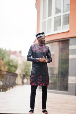 Yakışıklı afro amerikan adam geleneksel giysiler, kap ve giyiyor 