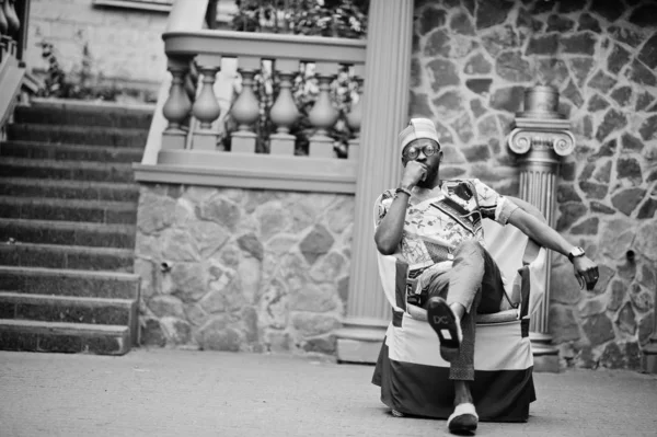 Handsome afro american man wearing traditional clothes, cap and