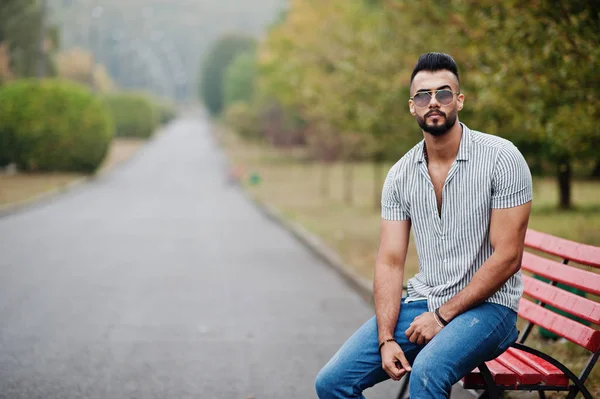 Модный высокий арабский бородач носит рубашку, джинсы и санглас — стоковое фото