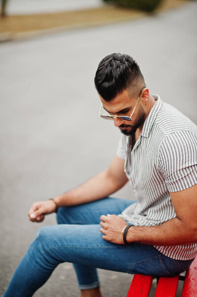 Fashionable tall arab beard man wear on shirt, jeans and sunglas