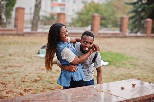 Dos estudiantes africanos con mochila en el patio de la universidad abraza un — Foto de Stock