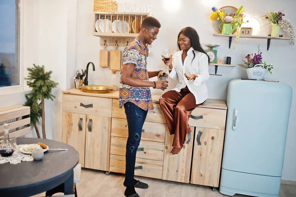 Afro american couple sweethearts drinking wine in kitchen at the