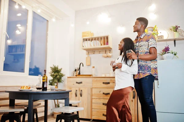 Afro american couple sweethearts drinking wine in kitchen at the — Stock Photo, Image