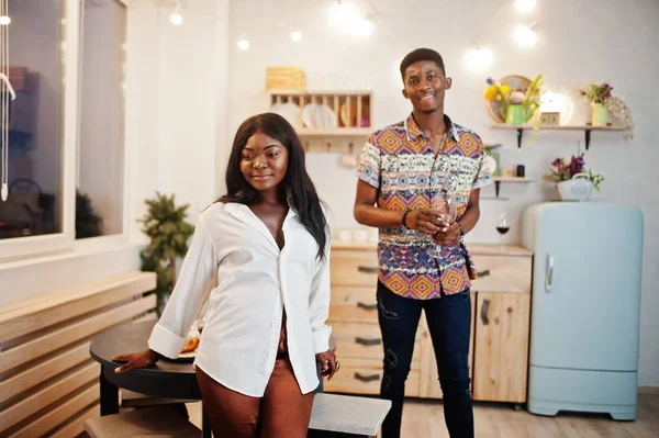 Afro american couple sweethearts drinking wine in kitchen at the