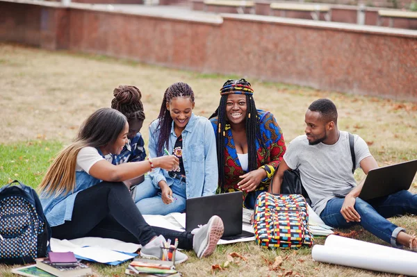 Group of five african college students spending time together on
