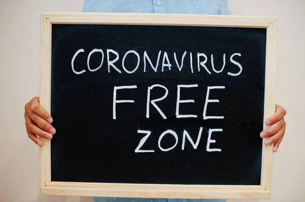 Free zone. Coronavirus concept. Boy hold inscription on the board.