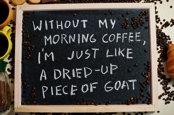 Without my morning coffee i am just like a dried-up piece of goat. Words on blackboard flat lay.