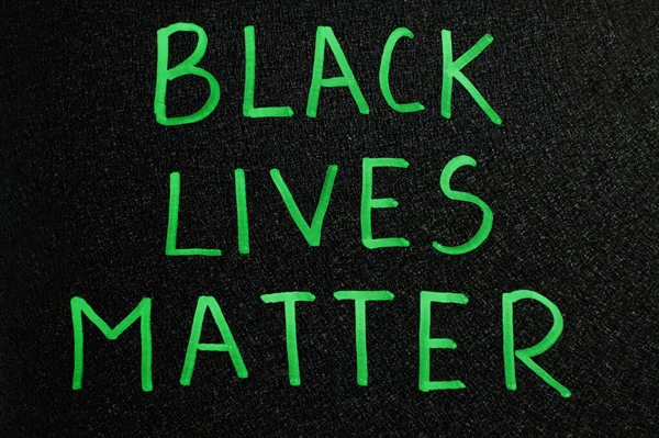 Black lives matter. Inscription green words on board.