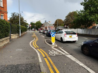 Manchester, İngiltere - 11 Eylül 2025: Manchester, İngiltere 'de arabalar, bisiklet şeridi ve kentsel atmosferi gösteren yoğun bir şehir yolu