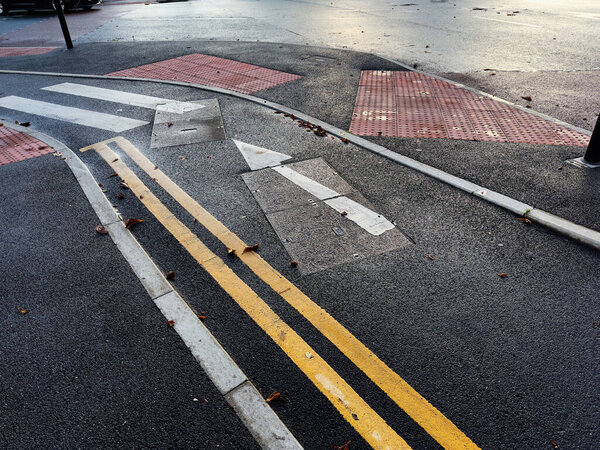 Detailed intersection with road markings and tactile surfaces in Manchester, UK