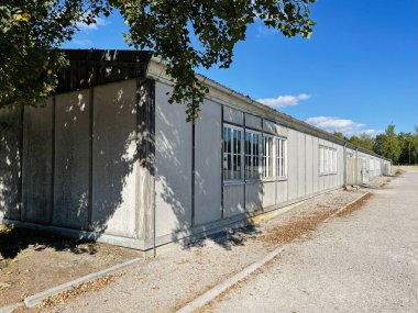 Dachau, Almanya - 29 Eylül 2022: Güneşli bir günde Dachau Toplama Kampı 'ndaki tarihi bir binanın dışı.